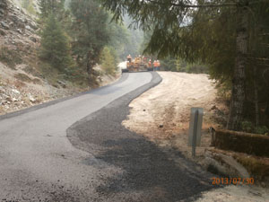 Del Norte County Road Crew apply paving to regraded road to prevent sediments from entering creek on Old Gasquet Toll Road
