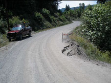 Collapsed culvert cause sinkhole in road shoulder and slipout Collapsed culvert cause sinkhole in road shoulder and slipout